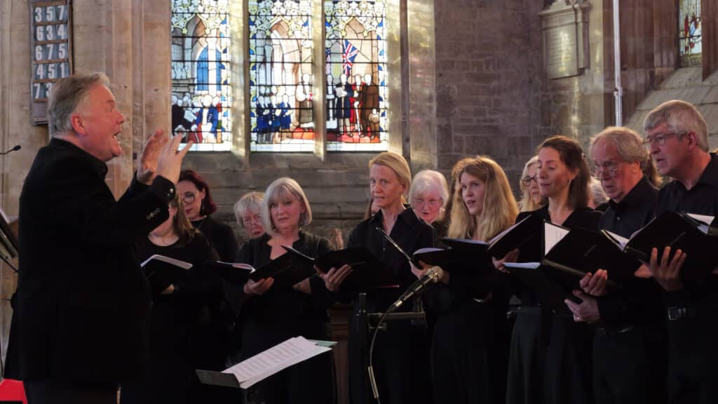 A close up shot of some sopranos and basses singing at The Bach Choir's 'Choral Classics' concert in Boston, Lincolnshire's 'The Stump' or St Botolph's Church